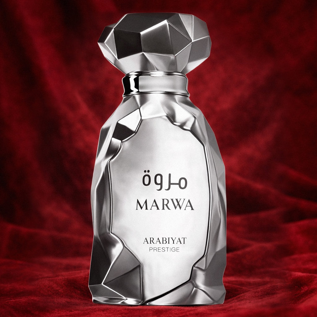 parfumfles van marwa arabiyat prestige. zilver asymmetrisch. op een rode achtergrond.